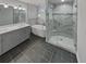 Bathroom with a walk-in shower, soaking tub, double vanity, and dark floor tiles at 2548 Loghaven Nw Dr, Atlanta, GA 30318