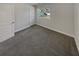 Carpeted bedroom with a large window and closet at 2548 Loghaven Nw Dr, Atlanta, GA 30318