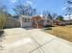 Charming home with a newly built front porch, large driveway, and neutral gray exterior paint at 2548 Loghaven Nw Dr, Atlanta, GA 30318
