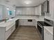 Modern kitchen featuring stainless steel appliances, light gray cabinets, and quartz countertops at 2548 Loghaven Nw Dr, Atlanta, GA 30318