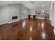 Open living room with a stone fireplace and hardwood floors, adjacent to the kitchen at 2548 Loghaven Nw Dr, Atlanta, GA 30318