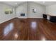 Open living room with beautiful wood floors, a fireplace with a stone accent wall, and built-in office area at 2548 Loghaven Nw Dr, Atlanta, GA 30318