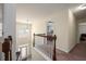 Bright hallway with staircase, dark wood banister, and arched window at 4365 Mulberry Ridge Ln, Hoschton, GA 30548