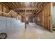 Unfinished basement featuring exposed wood beams and concrete flooring at 613 Woodstone Rd, Lithonia, GA 30058
