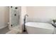 Elegant bathroom showcasing a modern shower, freestanding tub, and sleek fixtures at 613 Woodstone Rd, Lithonia, GA 30058