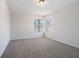 Well-lit bedroom with plush carpeting, ample natural light, and neutral color palette at 613 Woodstone Rd, Lithonia, GA 30058
