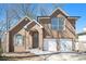 Charming brick two-story home with attached two car garage and arched front entry at 613 Woodstone Rd, Lithonia, GA 30058
