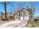 Two-story brick home featuring a two-car garage and well-manicured lawn at 613 Woodstone Rd, Lithonia, GA 30058