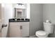 Stylish half-bath with modern fixtures, granite countertop, and decorative mirror at 613 Woodstone Rd, Lithonia, GA 30058