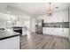 Modern white kitchen with stainless steel appliances and contrasting black countertops at 613 Woodstone Rd, Lithonia, GA 30058