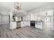 Modern white kitchen with stainless steel appliances and contrasting black countertops at 613 Woodstone Rd, Lithonia, GA 30058