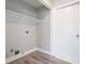 Practical laundry area with shelving and utility connections for washer and dryer at 613 Woodstone Rd, Lithonia, GA 30058