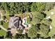 Aerial view of a grand estate with a backyard pool, golf course access, and mature trees at 8480 St Marlo Fairway, Duluth, GA 30097