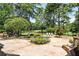 An expansive backyard with a pool, lush landscaping, and a view of the golf course at 8480 St Marlo Fairway, Duluth, GA 30097