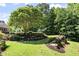 Beautifully landscaped backyard with mature trees at 8480 St Marlo Fairway, Duluth, GA 30097