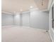 Unfinished basement with neutral paint, carpeted flooring, and window at 8480 St Marlo Fairway, Duluth, GA 30097