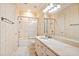 Bathroom featuring tiled floors and walls, shower-tub combo, and marble countertops at 8480 St Marlo Fairway, Duluth, GA 30097