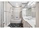 Bathroom with a shower/tub, a marbled vanity sink, and patterned wallpaper and flooring at 8480 St Marlo Fairway, Duluth, GA 30097