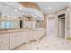 Luxurious bathroom with dual vanity, white cabinets, and marble tile flooring at 8480 St Marlo Fairway, Duluth, GA 30097