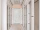 Walk-in closet with full-length glass door cabinets at 8480 St Marlo Fairway, Duluth, GA 30097