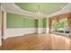 Bright dining room with hardwood floors, a chandelier, and a large window with a garden view at 8480 St Marlo Fairway, Duluth, GA 30097