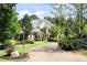 Charming two-story brick home with lush landscaping and a circular brick driveway at 8480 St Marlo Fairway, Duluth, GA 30097