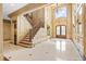 Elegant foyer with a grand staircase, high ceilings, and ornate details showcasing classic design at 8480 St Marlo Fairway, Duluth, GA 30097
