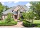 Beautiful brick and stone home showcasing manicured landscaping and a welcoming entrance at 8480 St Marlo Fairway, Duluth, GA 30097