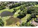 A picturesque golf course features a bridge crossing a tranquil lake, mature trees and pristine green lawns at 8480 St Marlo Fairway, Duluth, GA 30097