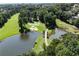 A beautifully designed golf course with a bridge over a lake and mature landscaping at 8480 St Marlo Fairway, Duluth, GA 30097