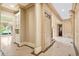 Spacious entrance hallway featuring marble tile, detailed trim work and built in cabinets at 8480 St Marlo Fairway, Duluth, GA 30097