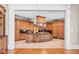Open-concept kitchen featuring a large island, custom cabinetry, and tile flooring at 8480 St Marlo Fairway, Duluth, GA 30097