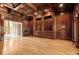 Wood-paneled living room with hardwood floors and built in bookshelves at 8480 St Marlo Fairway, Duluth, GA 30097