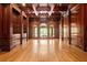 Wood-paneled living room with hardwood floors, coffered ceilings, and expansive windows at 8480 St Marlo Fairway, Duluth, GA 30097