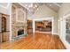 Inviting living room with a stone fireplace, built-in bookshelves, and wood flooring at 8480 St Marlo Fairway, Duluth, GA 30097