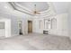 Large main bedroom featuring built-in shelving, cabinets, and a tray ceiling with a ceiling fan at 8480 St Marlo Fairway, Duluth, GA 30097