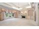Serene main bedroom featuring a fireplace, a chandelier, and windows overlooking a beautiful backyard at 8480 St Marlo Fairway, Duluth, GA 30097