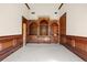 Home office with coffered ceiling, rich wood trim, and large built in bookcase at 8480 St Marlo Fairway, Duluth, GA 30097