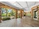 Covered outdoor patio with stone flooring, brick archways, and scenic views at 8480 St Marlo Fairway, Duluth, GA 30097