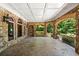 Outdoor patio featuring brick archways, stone flooring, and wrought iron railing at 8480 St Marlo Fairway, Duluth, GA 30097