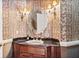 Elegant powder room with custom wallpaper and marble countertop at 8480 St Marlo Fairway, Duluth, GA 30097
