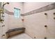 Large walk-in shower with multiple showerheads, bench and stained glass window at 8480 St Marlo Fairway, Duluth, GA 30097