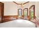 Sitting room with carpet, paneled walls and a large window with view of the yard at 8480 St Marlo Fairway, Duluth, GA 30097
