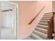 Carpeted stairway with wooden railing leads to another level of the home at 8480 St Marlo Fairway, Duluth, GA 30097