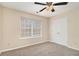 A serene bedroom with natural light, plush carpeting, and ample closet space for organized living at 132 Prity Ct, Mcdonough, GA 30253