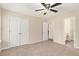 Bedroom featuring neutral carpeting, an open doorway to a bathroom, and a double-door closet at 132 Prity Ct, Mcdonough, GA 30253