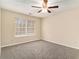Bedroom featuring a ceiling fan, plush carpeting, and bright window light at 132 Prity Ct, Mcdonough, GA 30253