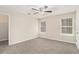 Neutral bedroom with carpet, two windows, and closet at 132 Prity Ct, Mcdonough, GA 30253