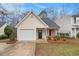 Charming single-story home with attached garage and well-maintained front yard landscaping at 132 Prity Ct, Mcdonough, GA 30253
