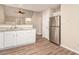 Kitchen featuring stainless steel refrigerator, granite countertops, and wood grain floors at 132 Prity Ct, Mcdonough, GA 30253